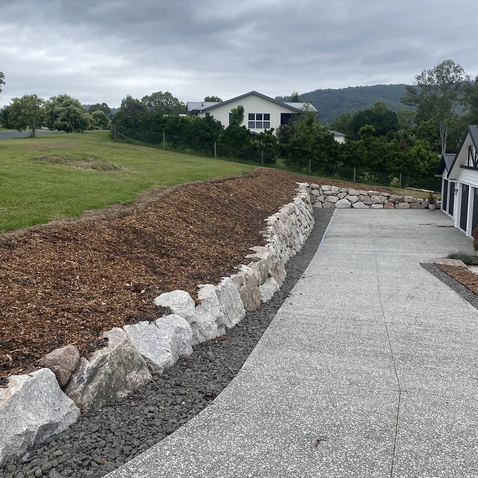 Fresh mulch and stone edging along pathway